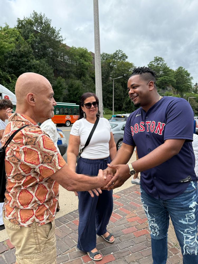 Councilor Santana shaking hands with a community member ahead of the parade.
