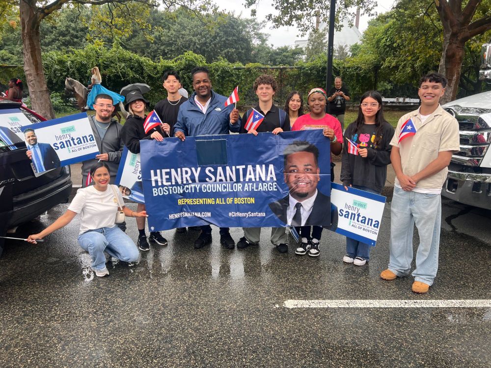 Team Santana with smiles and Puerto Rican Flags at the soggy start of the Puerto Rican Parade in Roxbury
