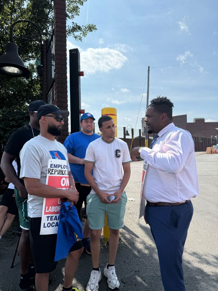 Councilor Santana in discussion with employees who are on strike outside of republic services