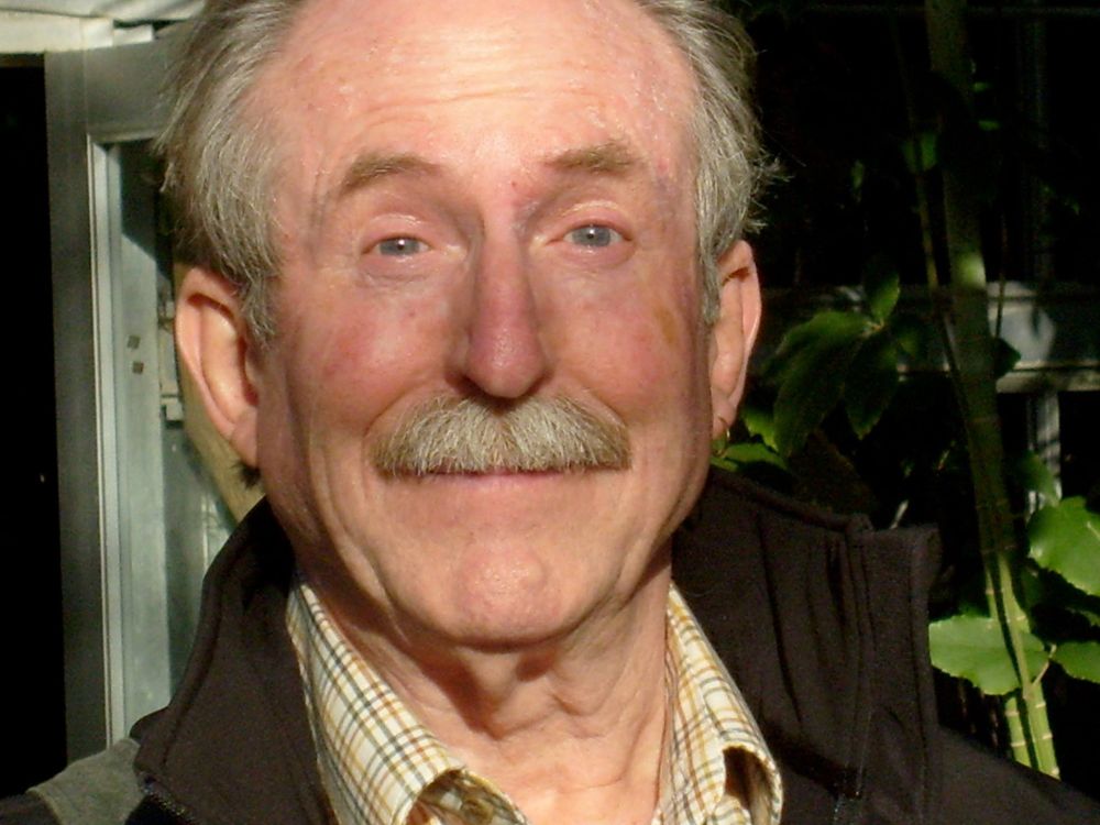 Close-up of sunlit Tom Raworth grinning broadly.