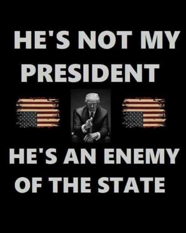 A picture of Trump with upside-down US flags. He's not my President; he's an Enemy of the State