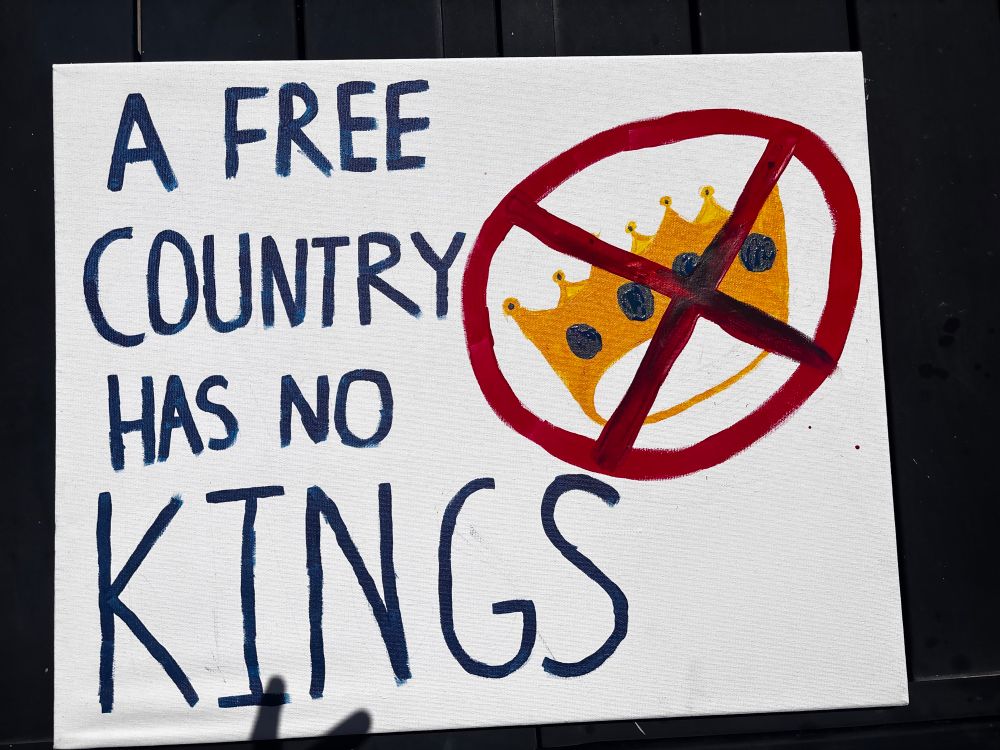 Hand painted No Kings sign: “A Free Country Has No Kings” with a crown painted with a red X across it