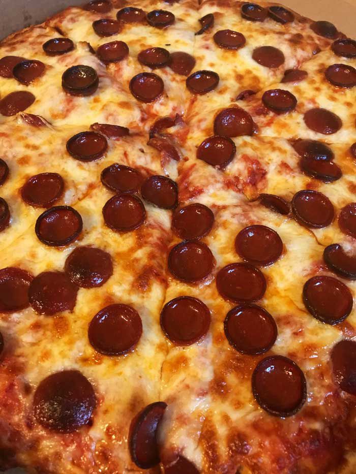 Cupped and Charred pepperoni buffalo pizza. The sauce is a bit sweeter, a thicker, softer crust.