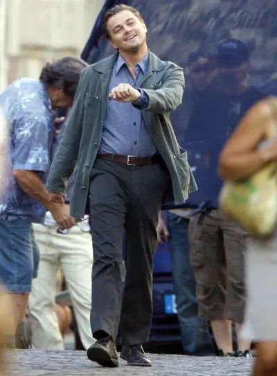 Whilst filming for Inception, DiCaprio was snapped by a photographer doing the above happy walk. And that amused a lot of people.

He does look exceedingly jolly in that picture. Like he’s content with it all and rambling on his super way.

We had a good think about why he’s possibly so happy there. And we came up with the following ideas:

He was on drugs.
He was just in a good mood.
That’s actually his angry face.
He was being controlled by aliens via mind manipulation.
He was rejoicing about himself being a good looking movie star.
He was acting (because that’s his job).
Whatever he was doing, this thing quickly became a bit of a sensation. And internet people began making compilation videos to ramp up the enjoyment factor.

Inception was also responsible for the hit “braaam” noise that almost every other trailer ever now has to use under international law. 