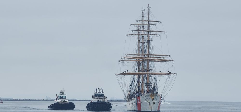 The USCG Barque Eagle accompanied by two tugboats Formerly known as Horst Wessel. Hence this reply. 