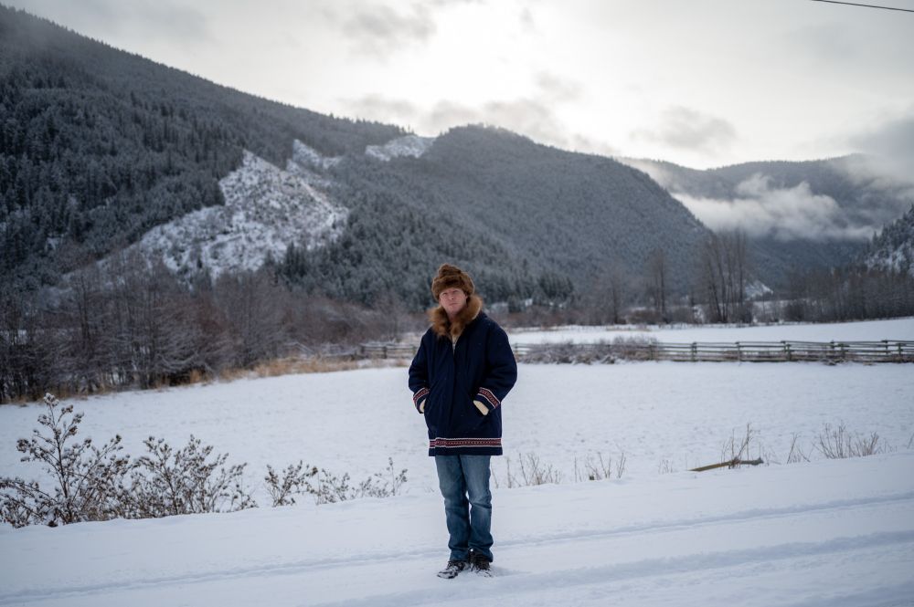 A man in a Grenfeld-Lined HBC winter coat from the 1960s in a snowy setting 