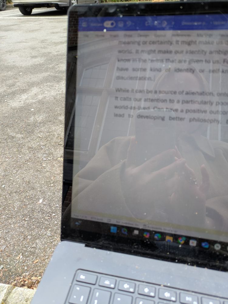 Laptop, concreted car park. 