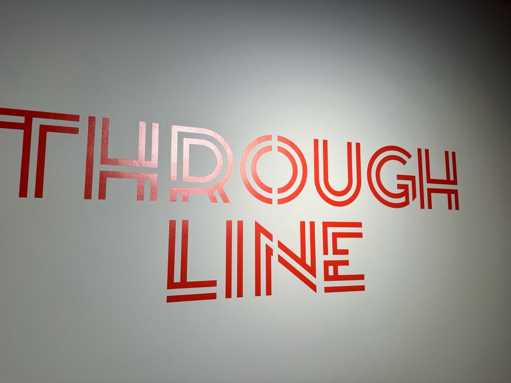 Text painted on wall: Through Line