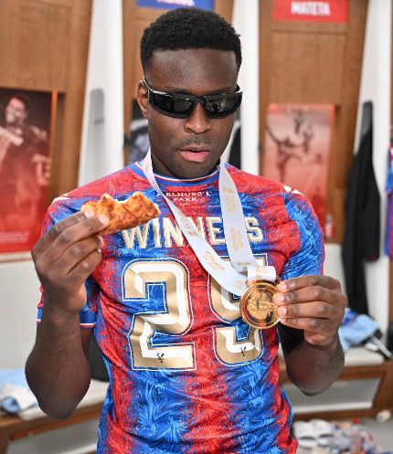 2025 FA Cup winning captain Marc, showing his winner’s medal while eating pizza