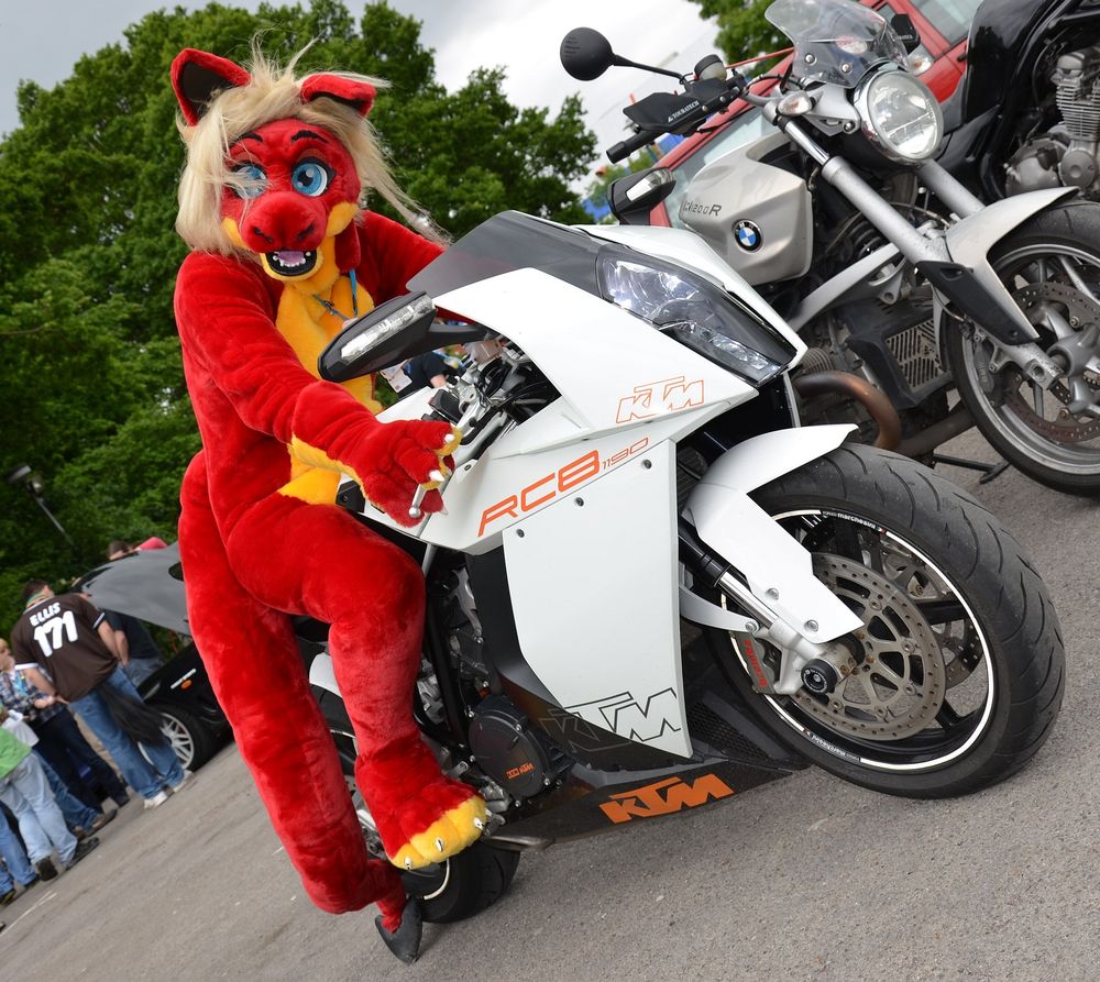A red dragon with a yellow belly sitting on a white motorbike
