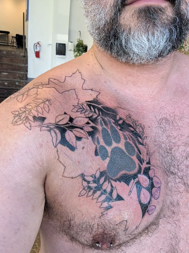 Leaves tattooed with wolf paw