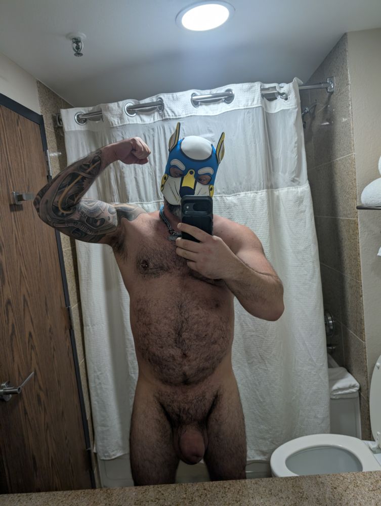 Naked man in pup hood