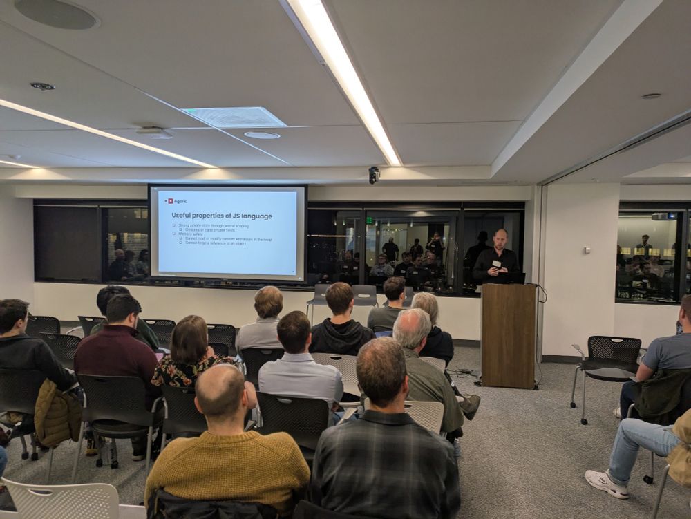 Mathieu speaking to a room of people about realms in JavaScript