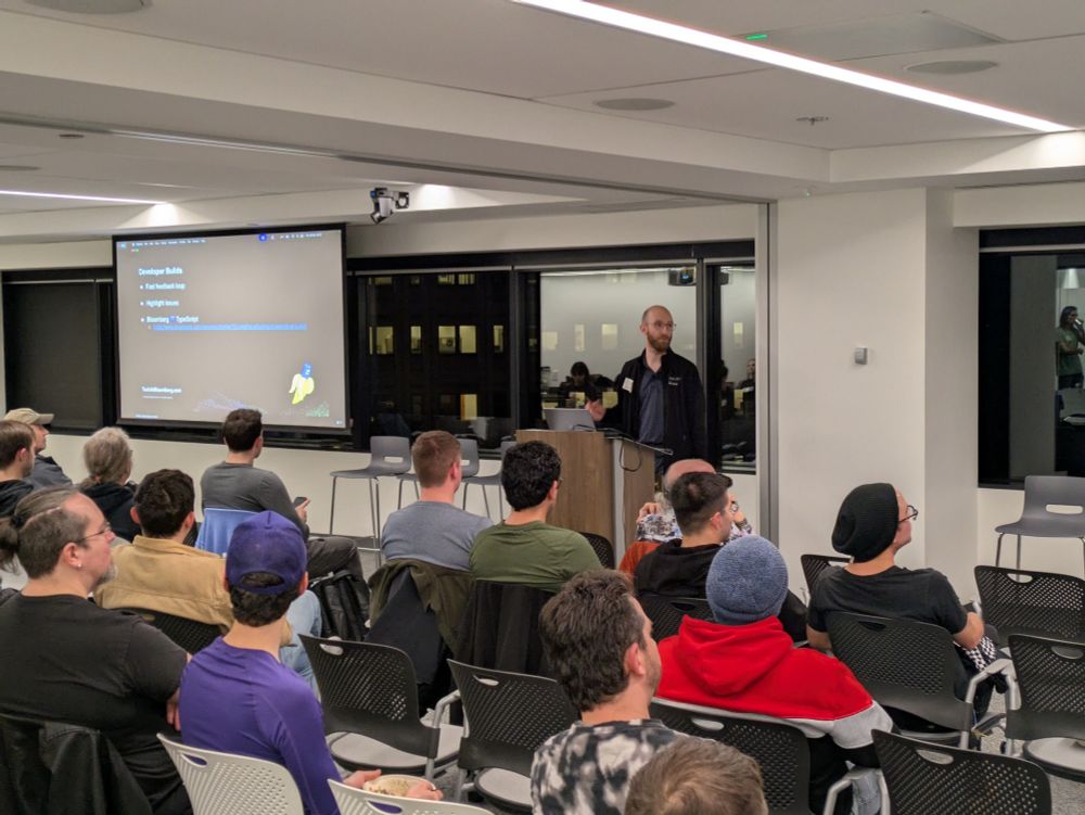 Ashley in front of a group of developers talking about ts-blank-space