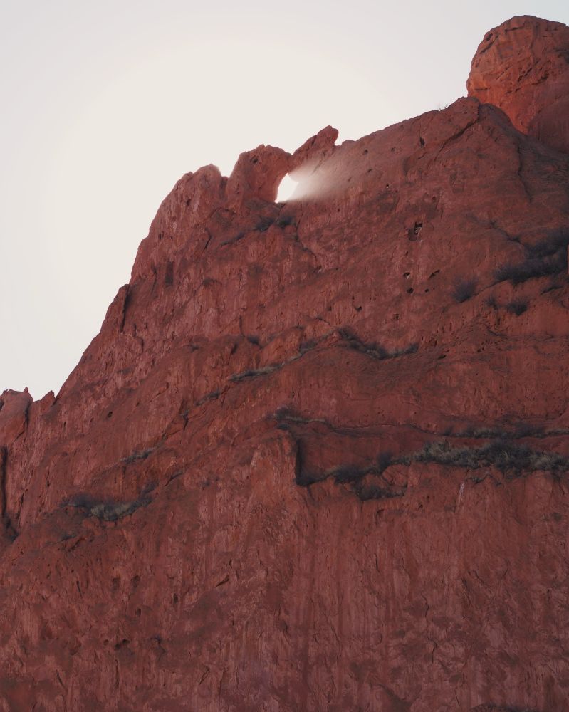 red orange rock formation with overcast sky
