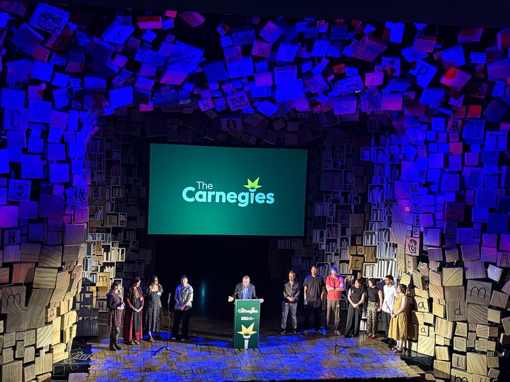 Photo of a stage with Carnegie finalists on it