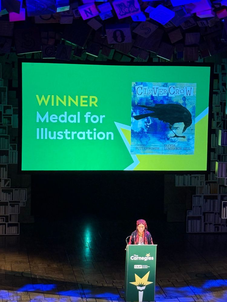 Photo of Olivia Lomenech Gill on stage accepting award