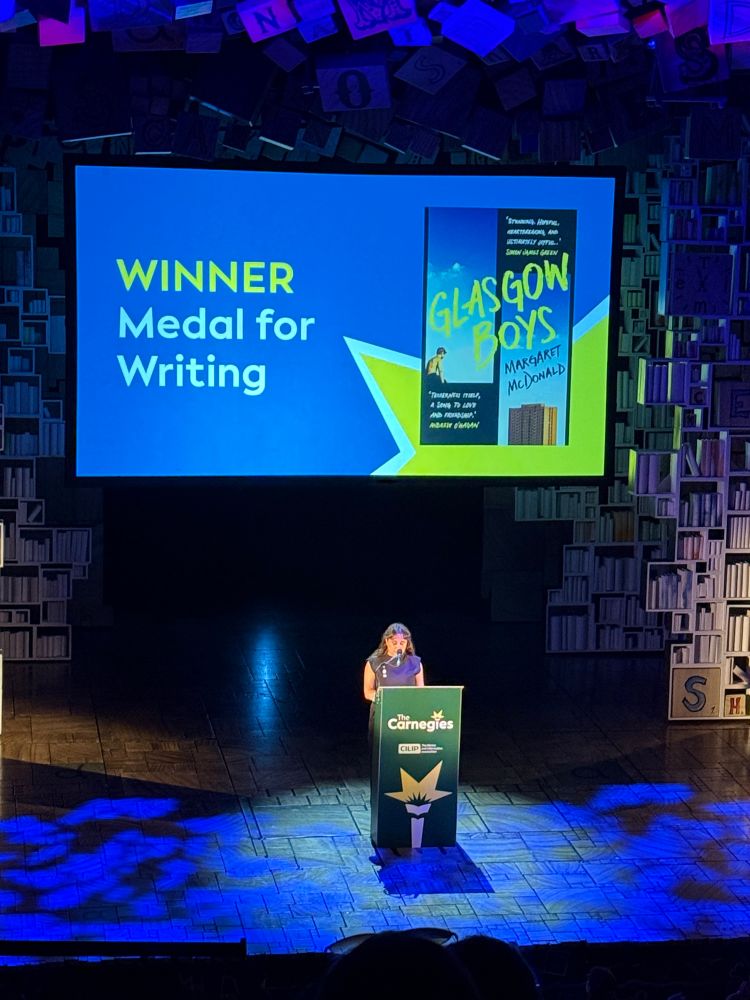 Photo of Margaret McDonald on stage accepting the prize