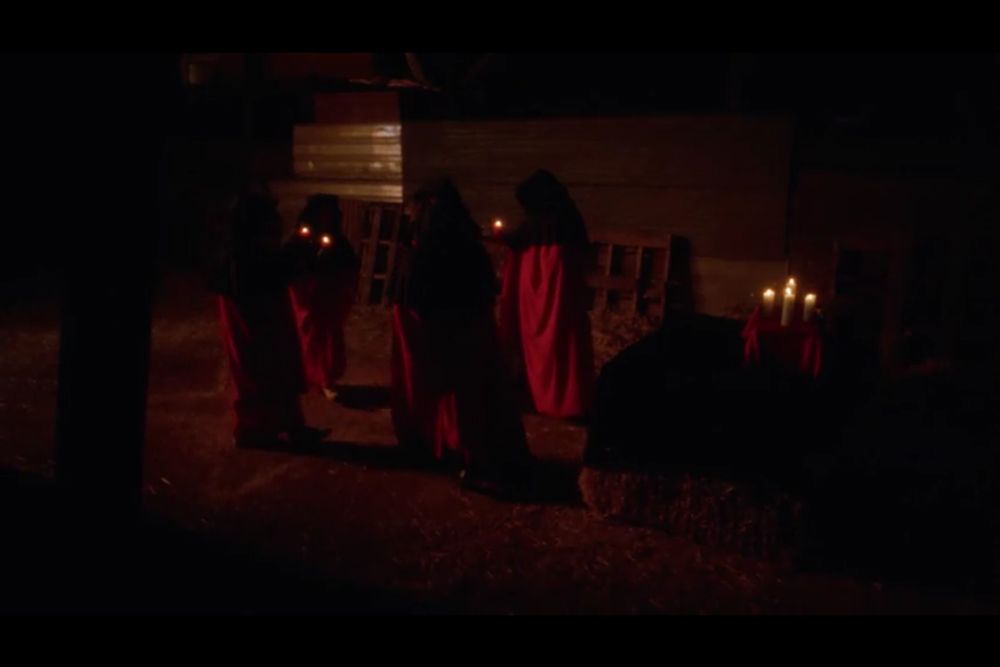 Satanic cult, in robes, with candles, you know the drill