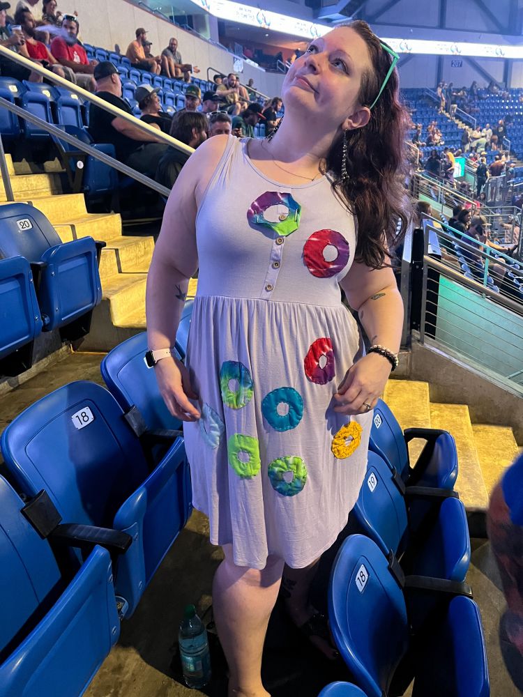 Me showing off my upcycled dress, standing by our concert seats and looking up awkwardly so as not to reveal the number of chins I’m capable of.