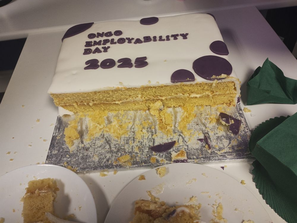 A square cake with white and purple frosting saying "Ongo Employability Day 2025"