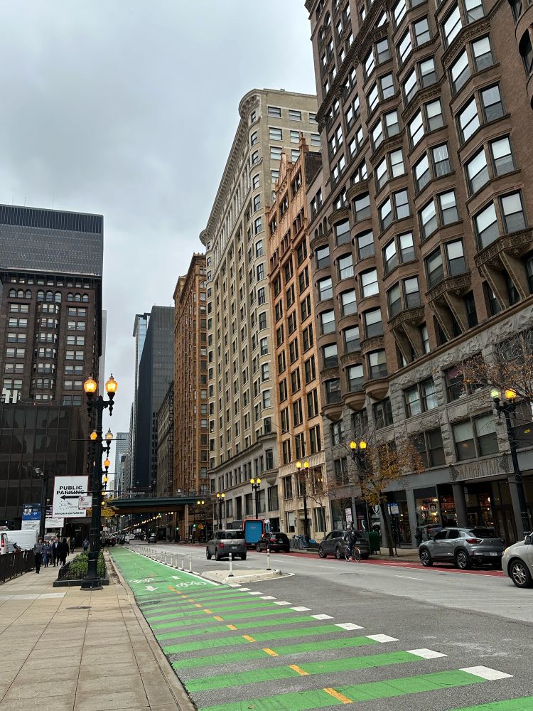 A look down Dearborn in Chicago, showing typical Loop buildings and a cycletrack.