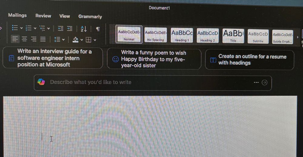A picture of a compterscreen open on Windows Word with a blank white document. Above the blank page it is giving writing prompts for AI, reading left to right as “Write an interview guide for a software engineer intern position at Microsoft”, “Write a funny poem to was Happy Birthday to my five-year-old sister”, and “Create an outline for a resume with headings” 