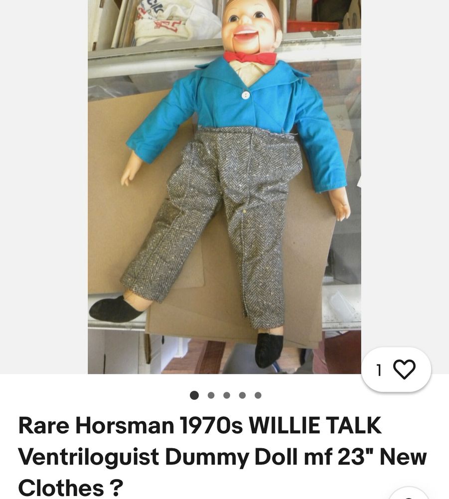 Screenshot of an eBay listing for a vintage ventriloquist dummy called Willie Talk which is a classic creepy looking white male puppet with short brown hair dressed in grey trousers, blue jacket, white shirt and red bow tie. He is lying on a table looking a bit like he’s drunk or has been murdered   