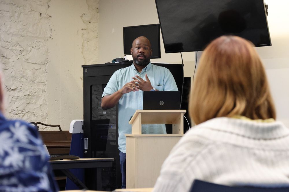 Michael speaks with people at The Whole Person about the work of BikeWalkKC. 
