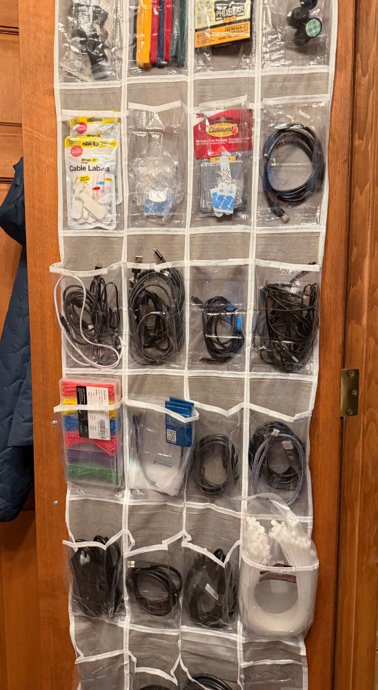 A back of a door show holder filled with cables and cable ties 