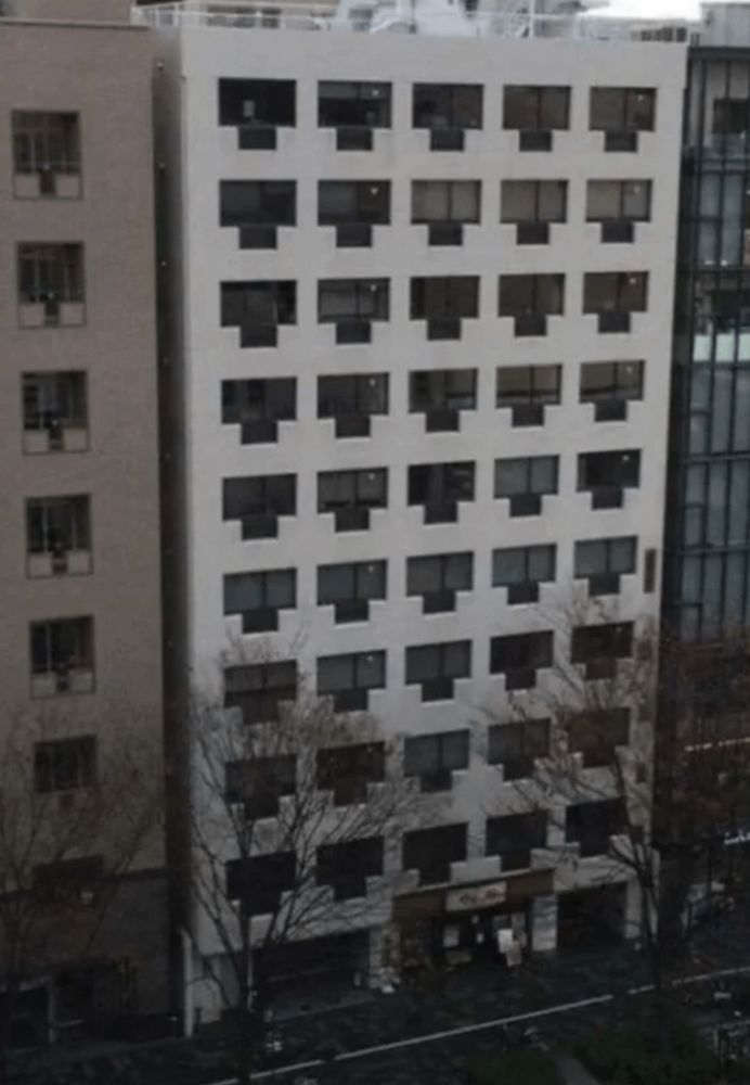 An apartment block where the windows and Juliet balconies look like network ports 