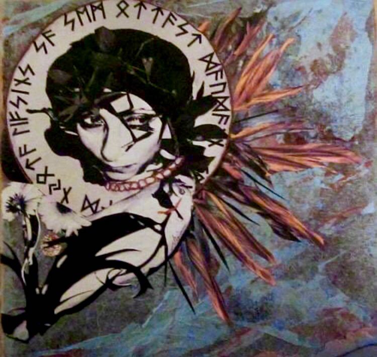 a paper collage i made depicting a stylized b&w photo of my face with dark eyes, surrounded by runic text and feather-like shapes on a textured background.
nina theda black.