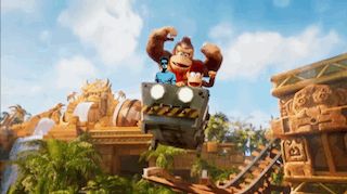 donkey kong is riding a roller coaster with another monkey