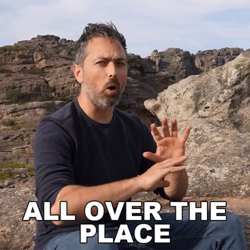 a man sitting on a rock with the words all over the place