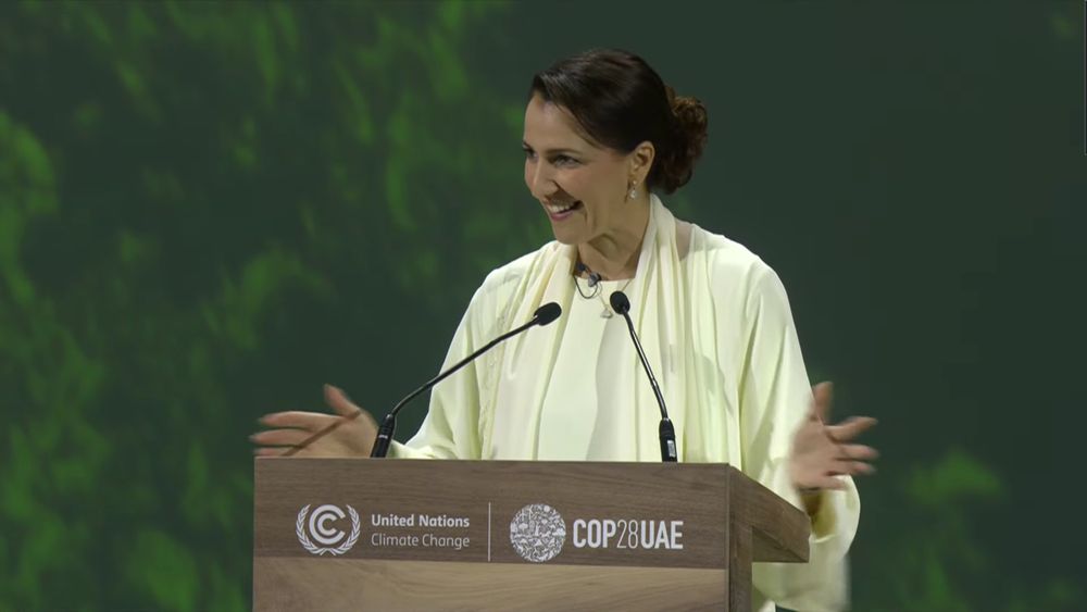 Mariam Almheiri stands behind a podium at COP28
