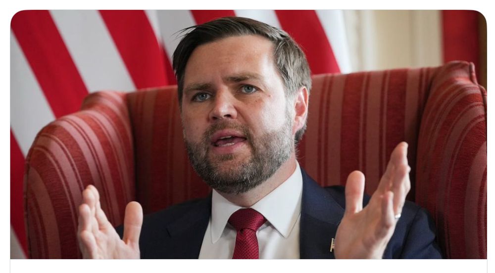 Photo of U.S. Vice President, J.D. Vance, sitting in a chair and holding his hand apart about 18 inches or half a meter.