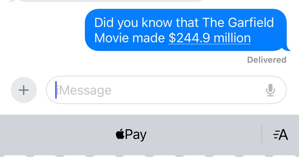 Screenshot of a text message that says "Did you know that The Garfield Movie made $244.9 million" with the Apple Pay logo in the suggestion bar of the keyboard 