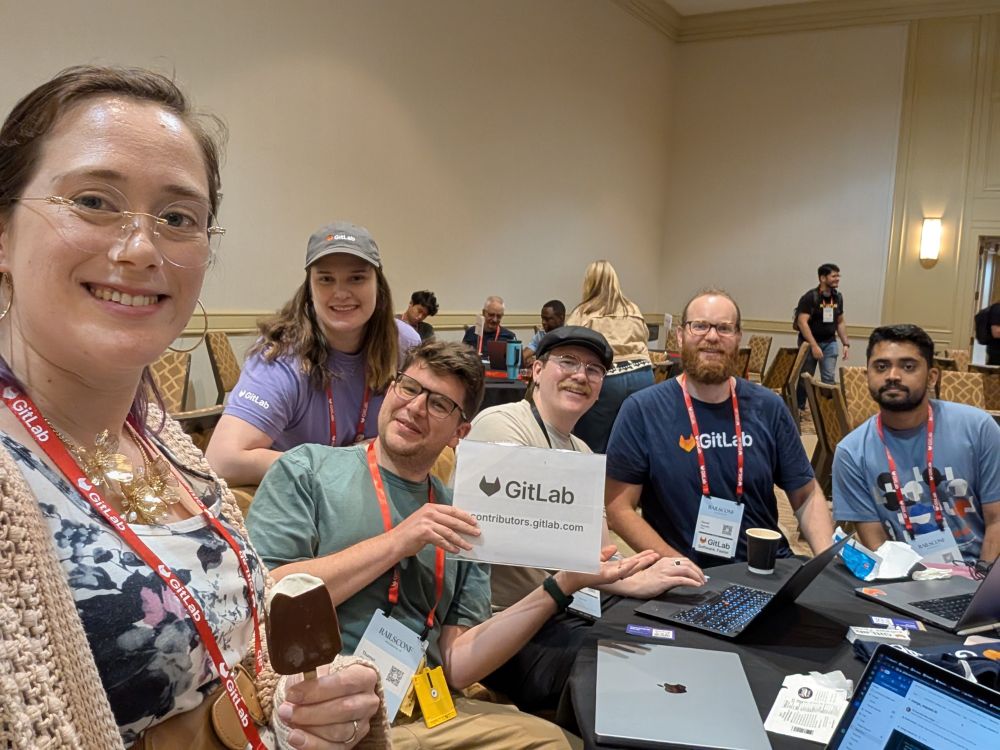 Selfie - Rachael, Thomas (who is holding the GitLab sign), Ariana, Josh, Daniel, and Manoj.