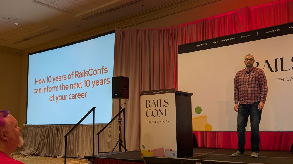 Kevin on stage, the slide is "How 10 years of RailsConfs can inform the next 10 years of your career"