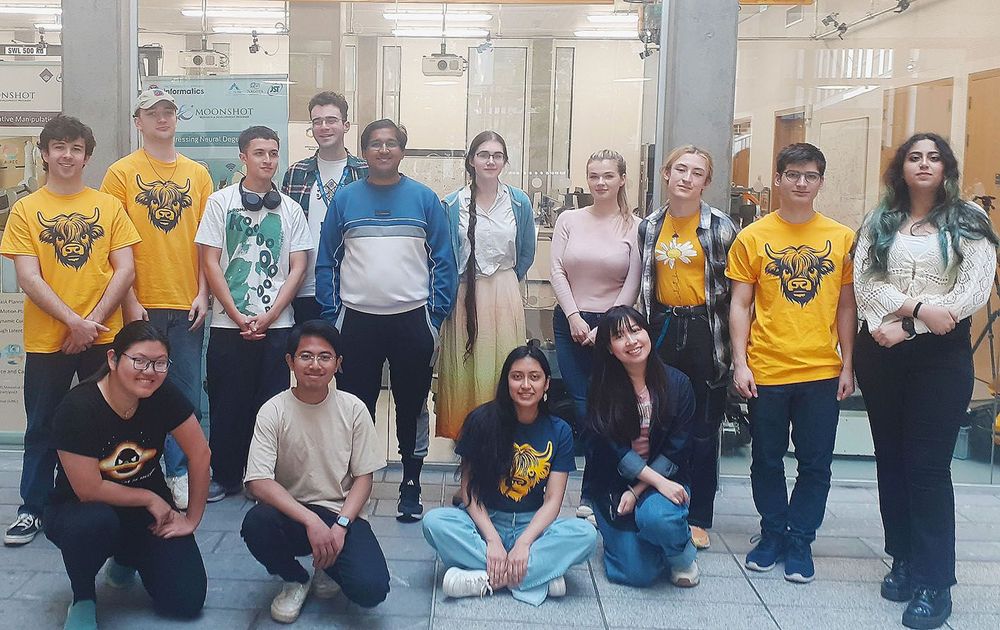 A group of 14 EPCC HPC Summer School students in the atrium of the Bayes Centre, Edinburgh.