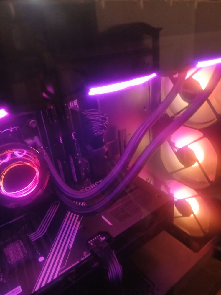 The interior of a gaming pc, looks a bit like a cyberpunk city, here with pink neons