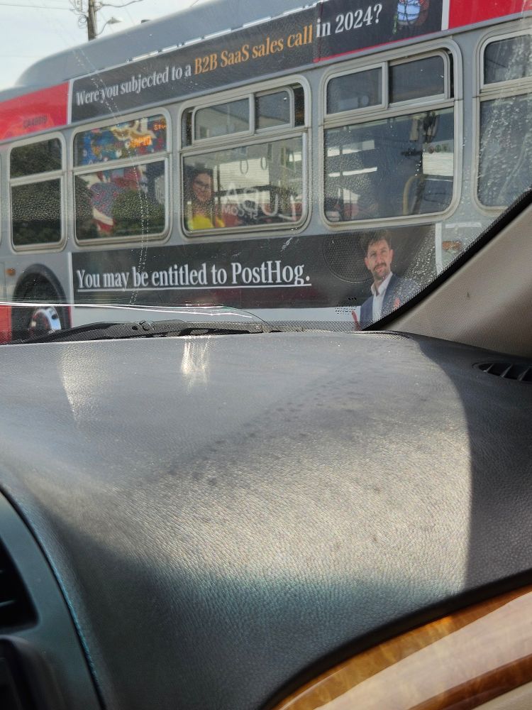 bus with an ad that says "You may be entitled to PostHog."