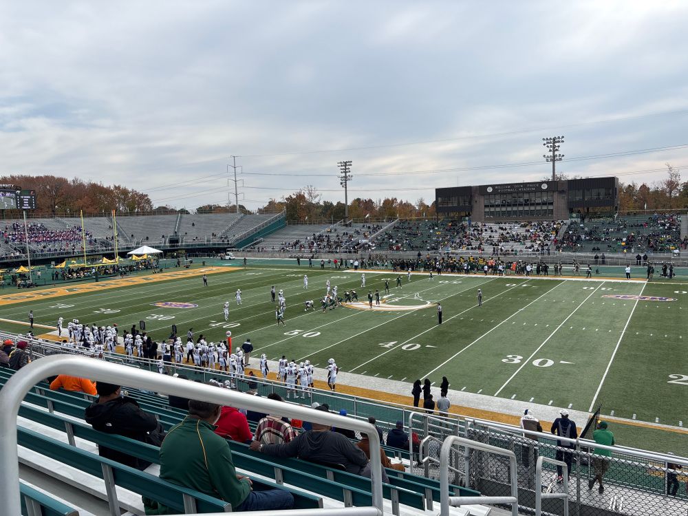 Football field with a team in white, Morgan State, and a team in green, Norfolk State. 