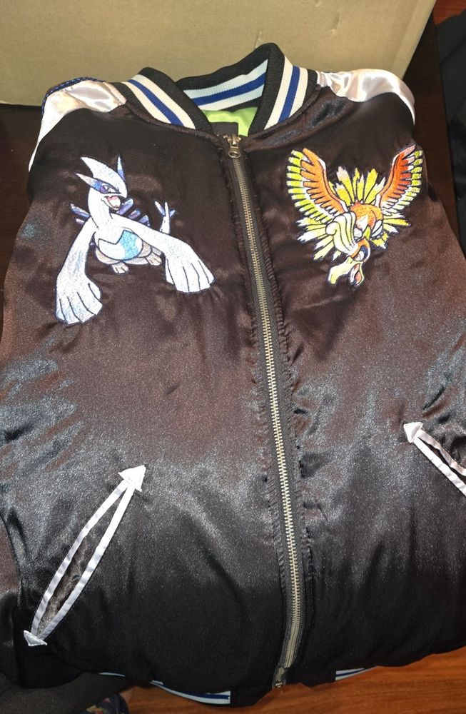 The jacket that came from the box featuring Lugia and Ho-Oh on the front.