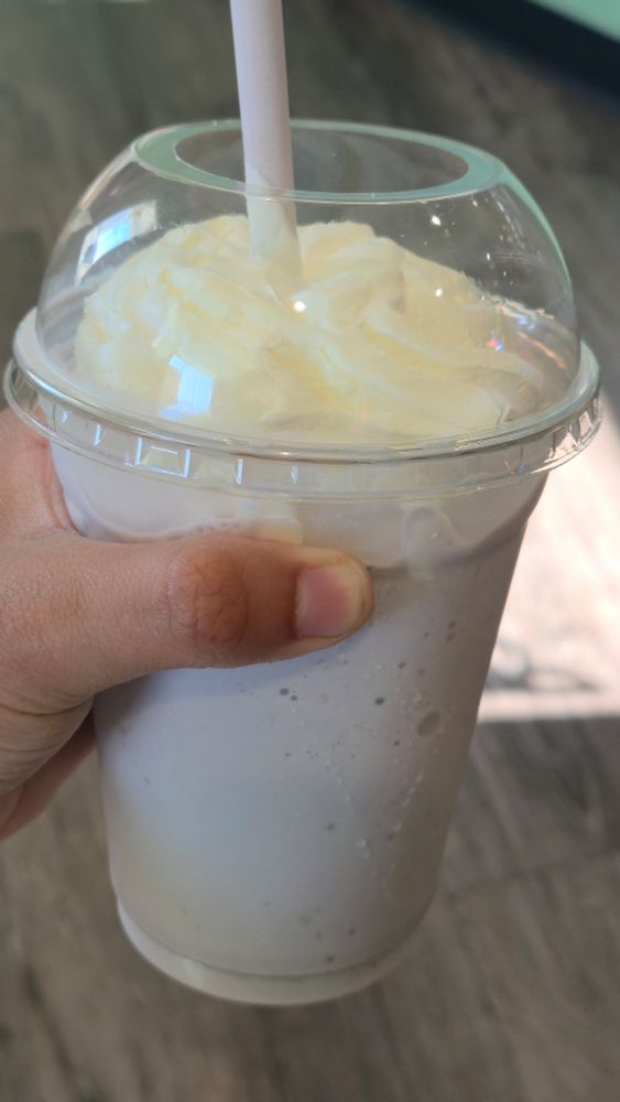 A Blueberry Cheesecake milkshake held by Vash