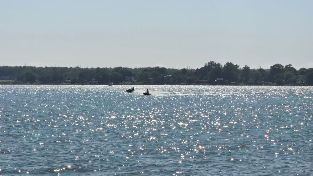 Two people riding sea-doos over the water at Solomon's Island 