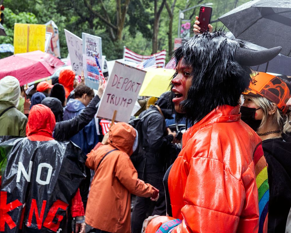 Horned woman looks on at No Kings Day peaceful march in NYC on June 14, 2025 Flags Day
