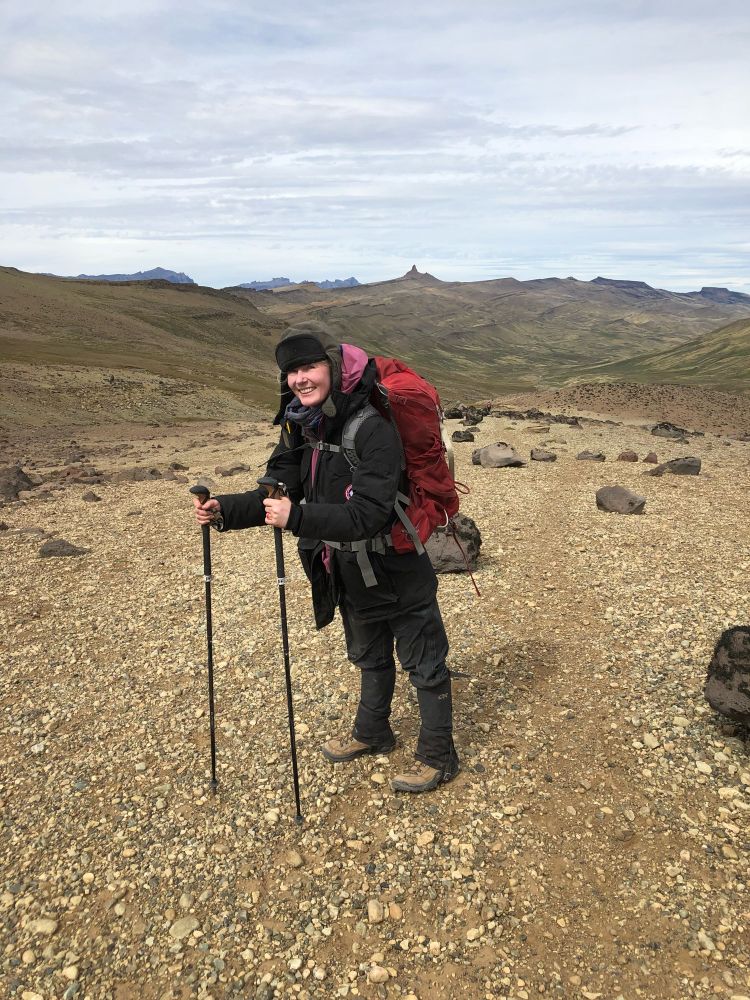 paleontologist carrying titanosaur vertebra thru the mountains 