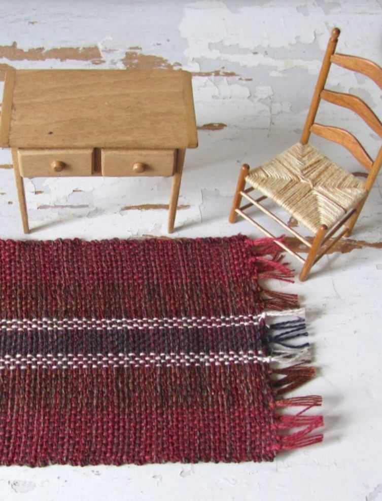 Dollhouse Miniature Rug, 1:12 Scale Inch to Foot Artisan Furniture Rustic Country Cabin Doll Rug, Handmade Hand Loom Woven Burgundy Red, Mahogany Brown, Navy Blue, and White Rug, shown with Ladderback Chair and 2 Drawer Side Table