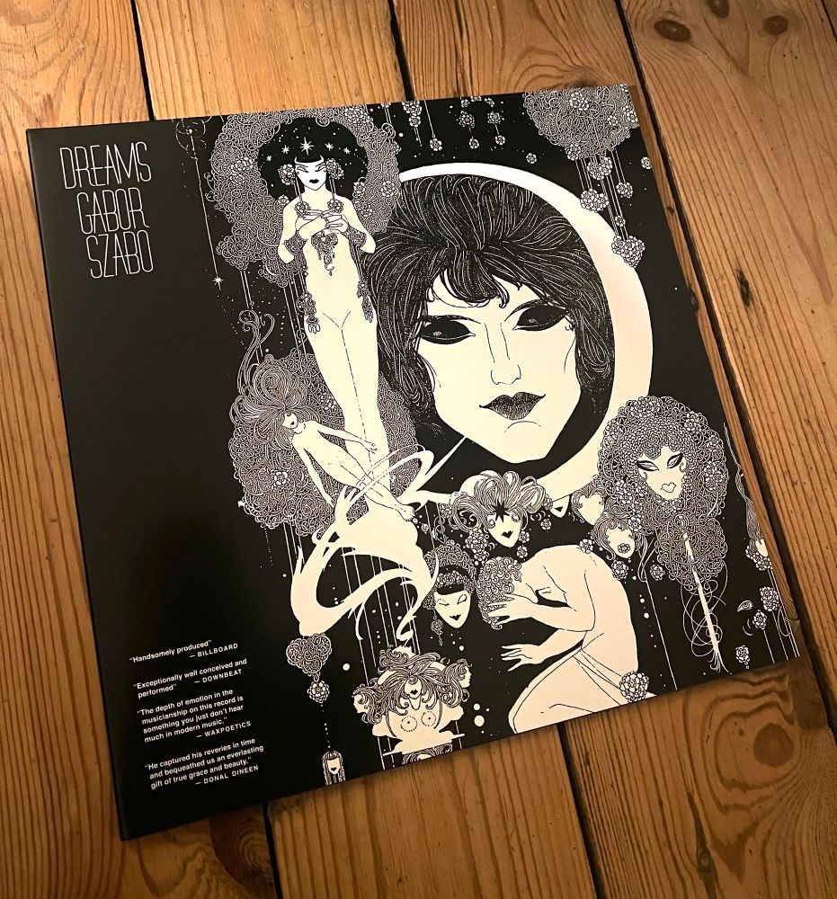 A vinyl record cover with black and white pagan like faces and beings in a dream like state